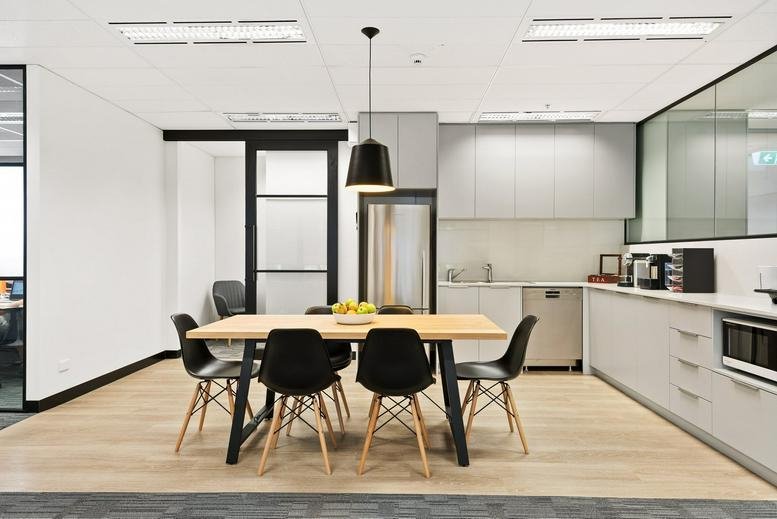 Spacious communal kitchen and dining area at 330 Collins Street, Melbourne, Victoria.