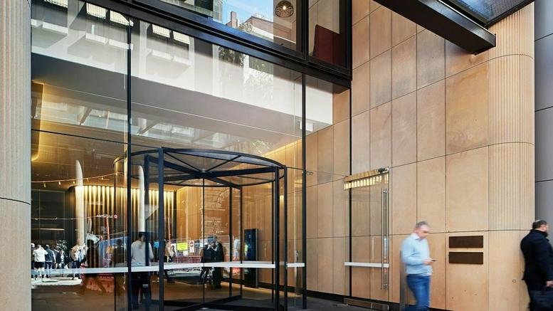 The glass entrance and tan stone facade of 333 George Street, Sydney, New South Wales.