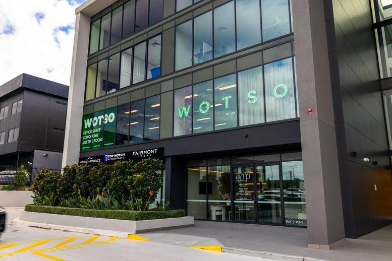 Exterior view of the multi-story glass building for WOTSO Gregory Hills at 39-47 Lasso Road.