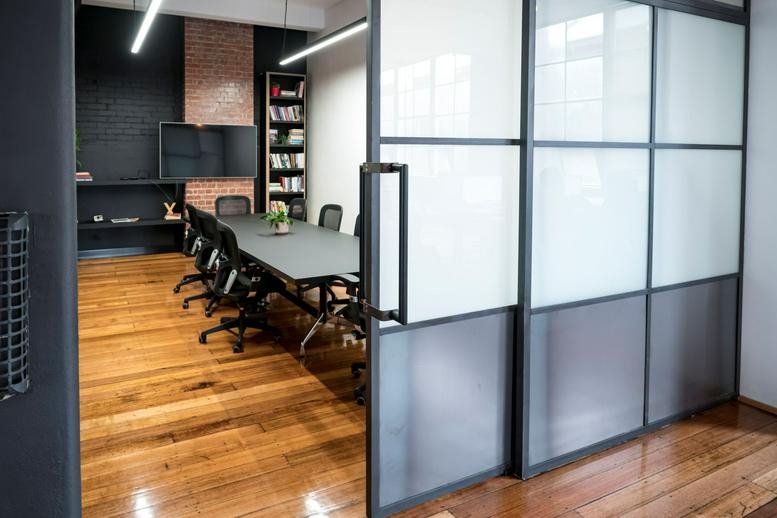 Modern boardroom at 41-43 Stewart Street, Richmond with frosted glass partitions.