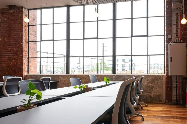 Bright open-plan workspace at 41-43 Stewart Street, Richmond with large industrial-style windows.
