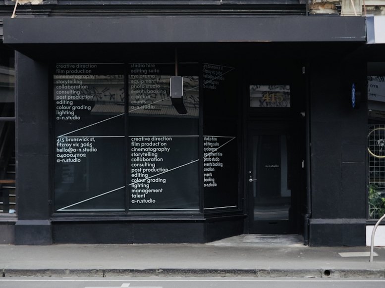 The black painted storefront and glass entrance of 415 Brunswick Street, Fitzroy.
