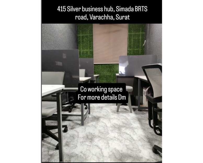Coworking space at Silver Business Hub, Suite 415 featuring desks with green living wall accents.