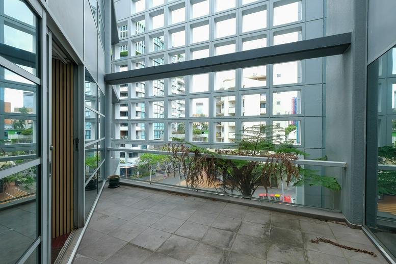 Exterior private balcony with a view of the surrounding city buildings.
