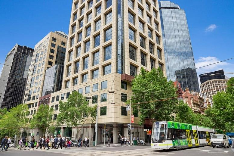 Exterior view of the classic stone and glass facade of 459 Collins Street.