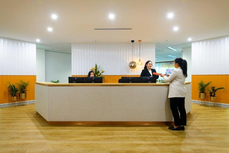 Modern lobby and reception area at 465 Victoria Avenue with orange accents.