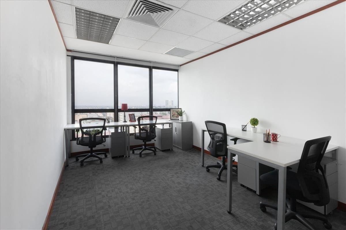 Bright four-person workspace at 49 Hai Ba Trung Street featuring large windows and city views.