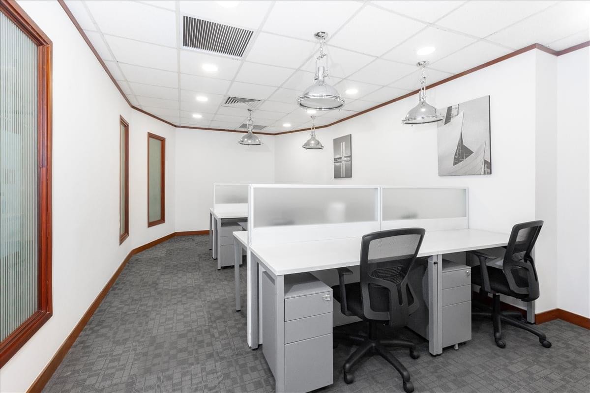 Modern open-plan workspace at 49 Hai Ba Trung Street with sleek desks and hanging lamps.