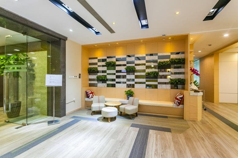 Modern communal lounge featuring a living wall with plants and comfortable seating.