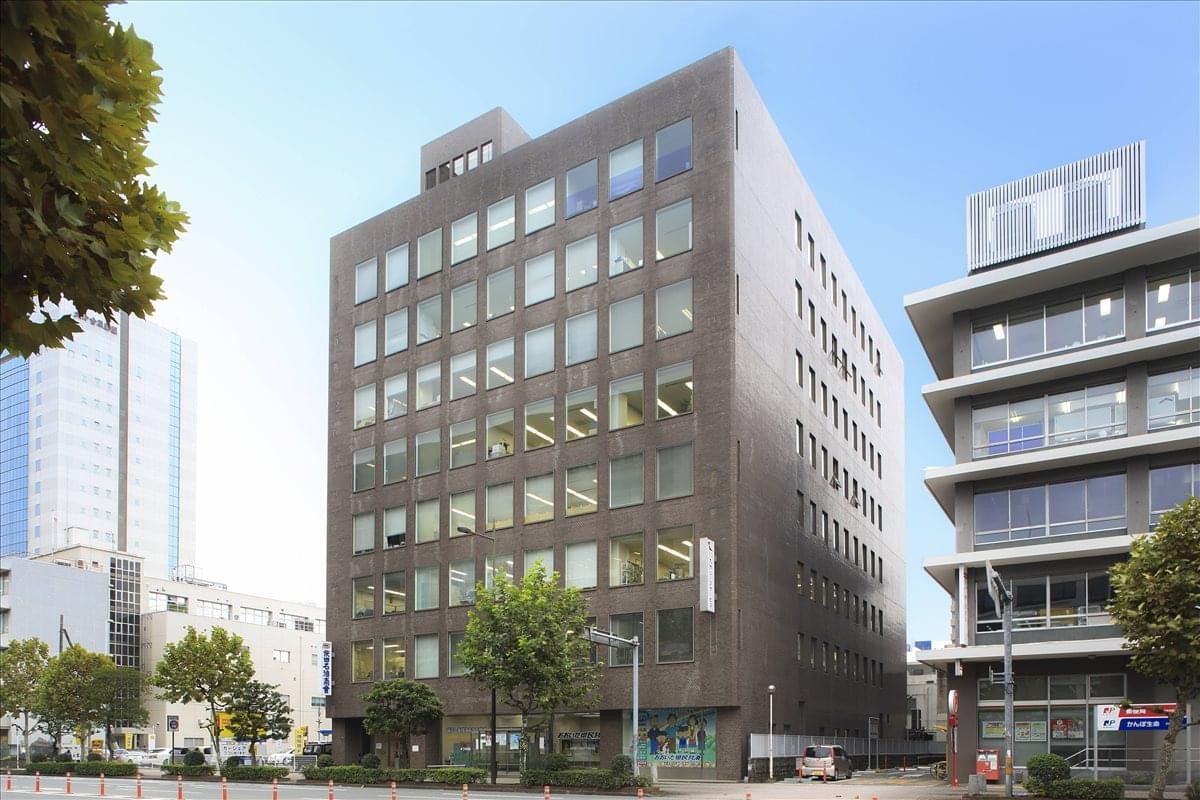 Exterior view of the dark brick facade of the 4F Oita Kowa Building.