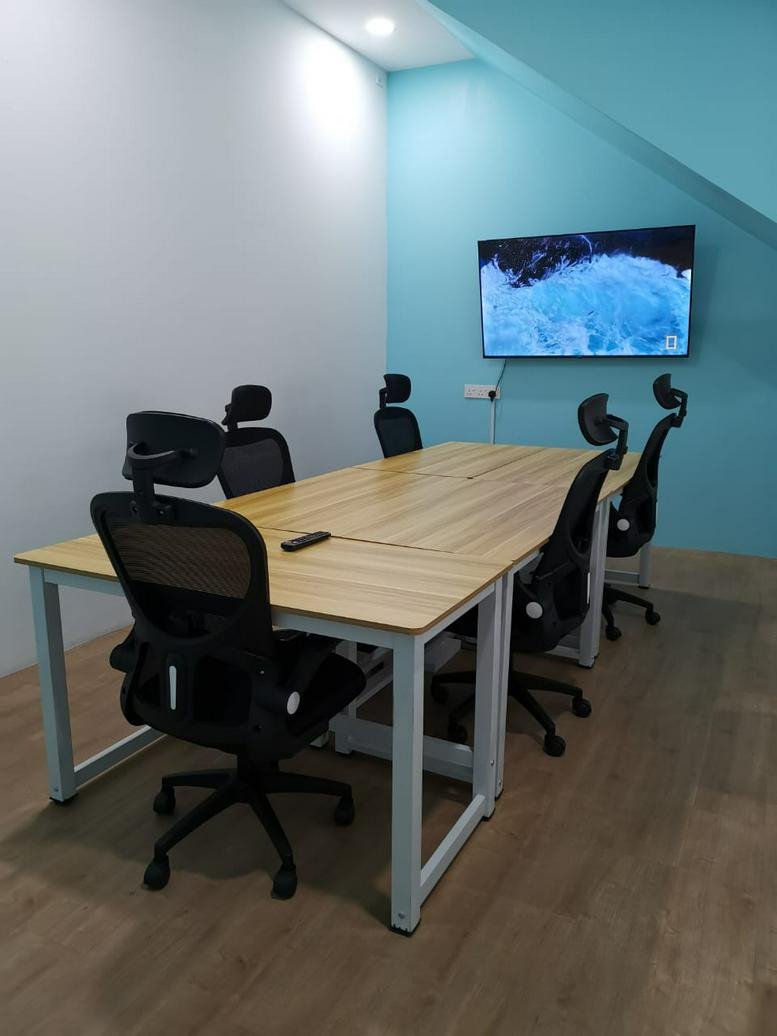 Meeting room at 50 Jalan Ekoperniagaan 1/3, Taman Ekoperniagaan with a large screen and wooden table.