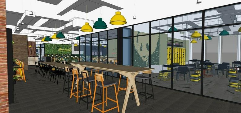 Spacious coworking area at 500 Guangdong Lu featuring high tables and vibrant hanging pendant lights.