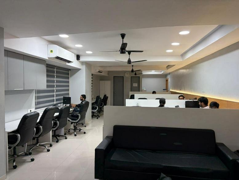 Spacious open-plan workspace at Skywalk The Element with modern white desks and black chairs.