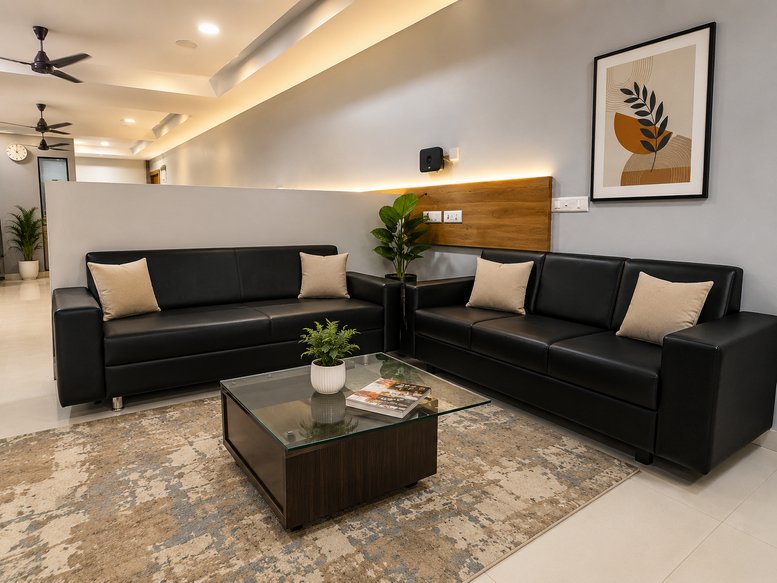 Reception lounge area at Skywalk The Element with black leather sofas and a glass coffee table.
