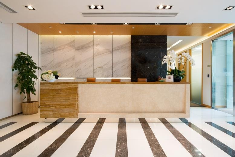 Sleek marble and wood reception area at Gubei International Financial Centre II.