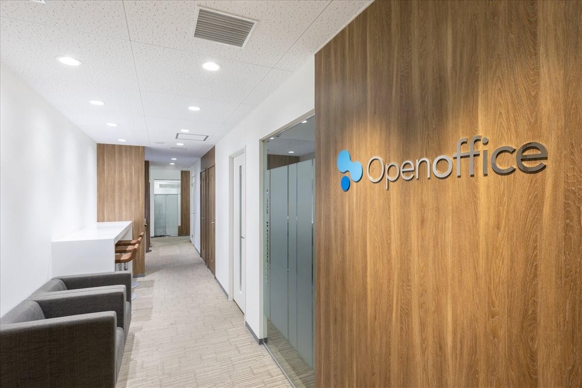 Branded reception area at 5F & 6F Links Meieki featuring a wood-paneled feature wall and comfortable seating.