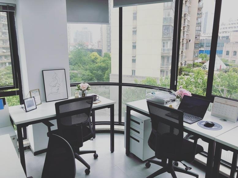 Bright open-plan office at 5G building A, 129 Da Tian Road with large curved windows and city views.