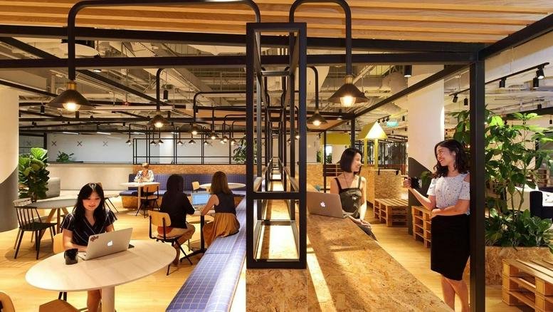 Spacious communal lounge and coworking area at 6 Raffles Boulevard, Marina Square.