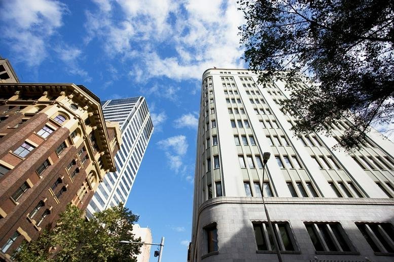Street view of buildings against a blue sky.