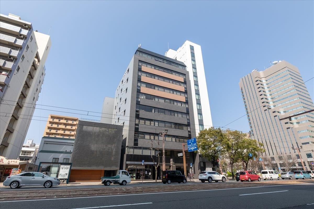 Full exterior view of the 6F IT Otemachi Building under a clear blue sky.