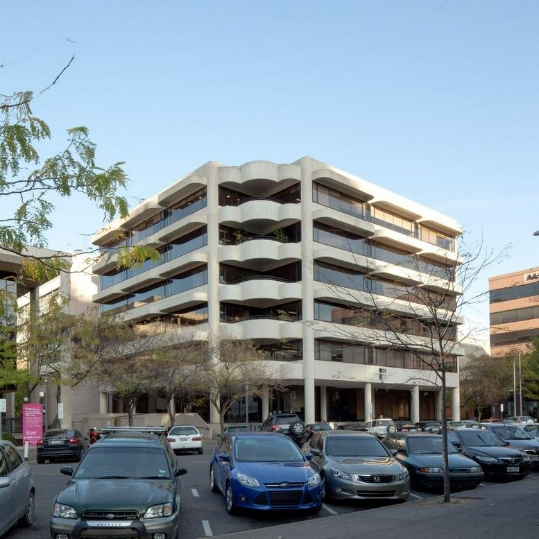 Exterior view of the white tiered office building at 70 Hindmarsh Square.
