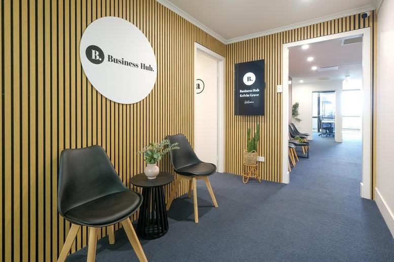 Reception at Business Hub Kelvin Grove featuring a wood-slat feature wall and stylish seating.