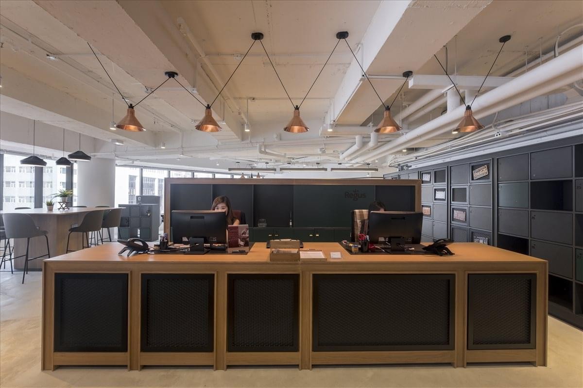 Reception desk area with wooden counters and industrial pendant lighting.