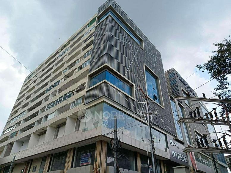 Exterior view of the modern glass and stone facade at Vasavi MPM Grand.