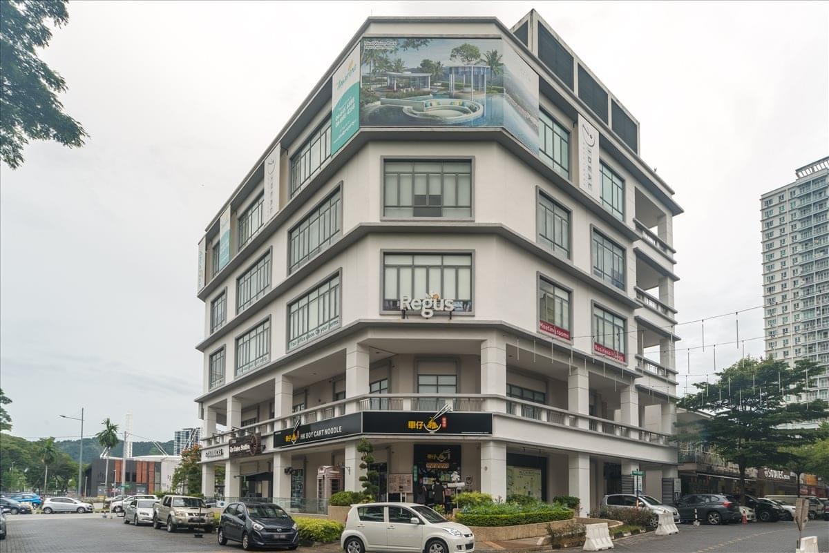 Corner exterior view of the multi-story commercial building Ideal@The One with signage.