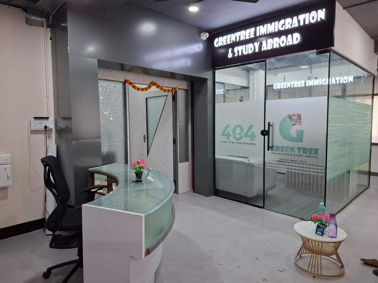 Entrance of Universe Coworks, 2nd Floor, 74A Salai Road, Tiruchirappalli with a curved glass reception desk.