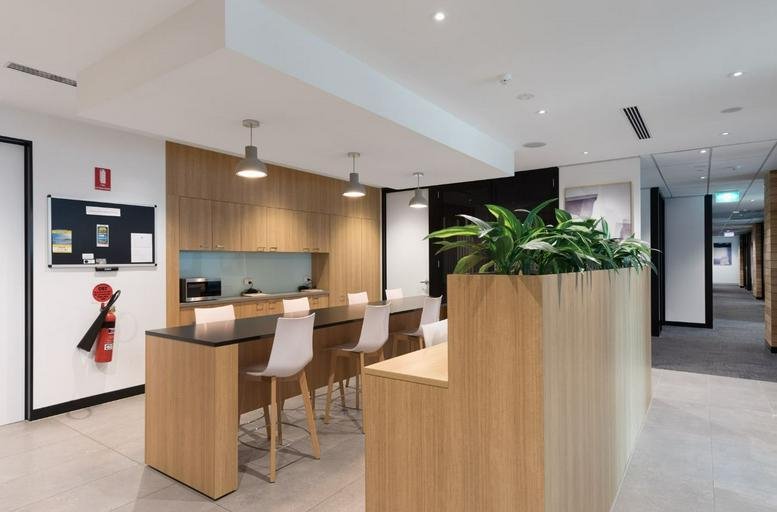 Kitchen and breakout area with wooden counters and potted plants at Lobby 1, Level 2, 76 Skyring Terrace.