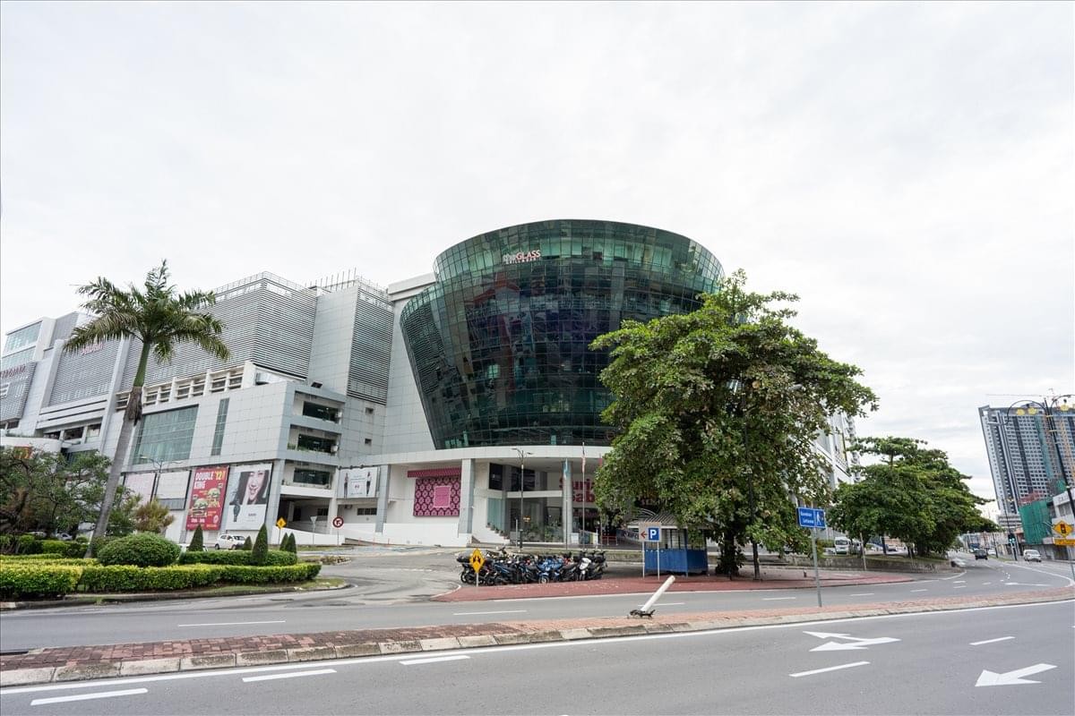 Exterior view of the curved glass facade at Suria Sabah Shopping Mall.
