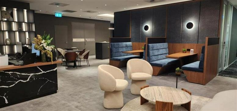Modern lounge area at 9 Castlereagh Street with marble reception desk and velvet booths.