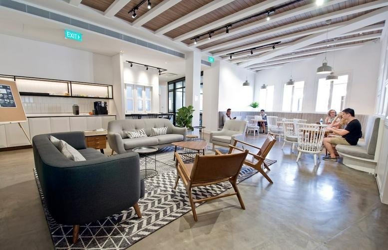 Spacious communal lounge and cafe area at 99 Duxton Road, Singapore with high beamed ceilings.