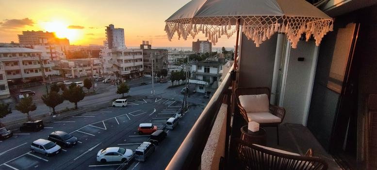 Sunset view from the balcony of Isahama Seaside Mansion, Suite A605, overlooking the city.