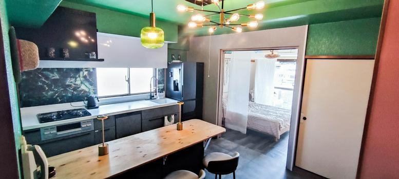 Spacious interior of Isahama Seaside Mansion, Suite A605 featuring a kitchen island and green ceiling.