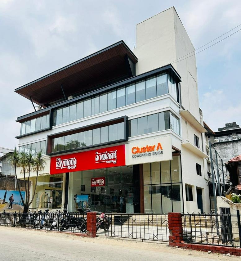 Exterior view of the white and glass office building at 3rd Floor, Above The Raymond Shop.