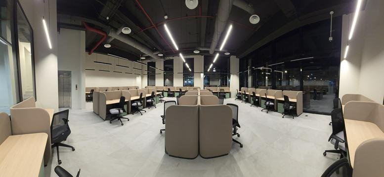 Large open-plan workspace at almathar, prince Sultan rd with rows of partitioned cubicles and bright overhead lighting.