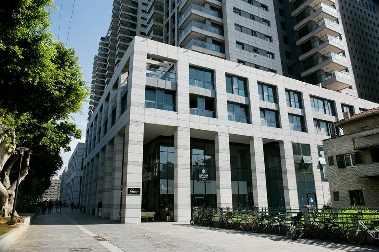 Exterior view of the modern stone and glass building at Aluf Kalman Magen 3, Sarona.