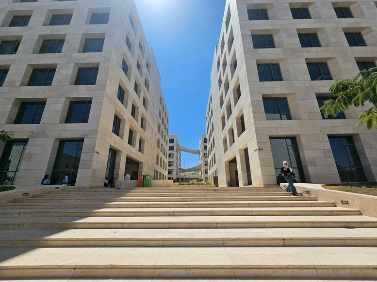 Exterior view of the modern stone facade of Building 15, King Hussein Business Park, Amman.