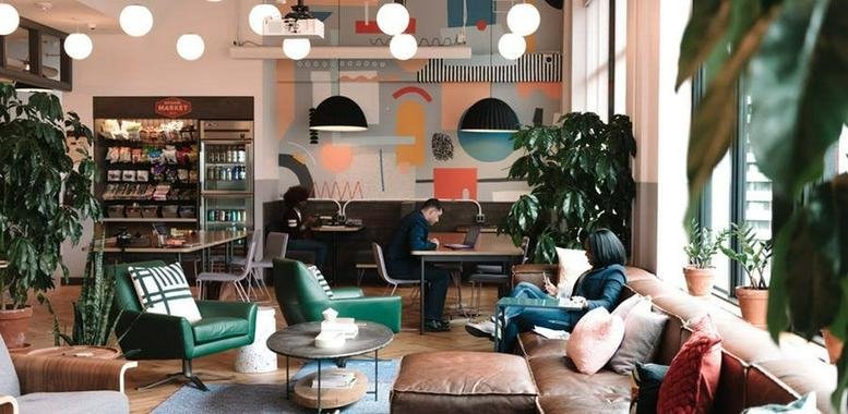 Spacious communal lounge with eclectic furniture and vibrant wall art at Ark Hills, 1 Chome-4-5 Roppongi.