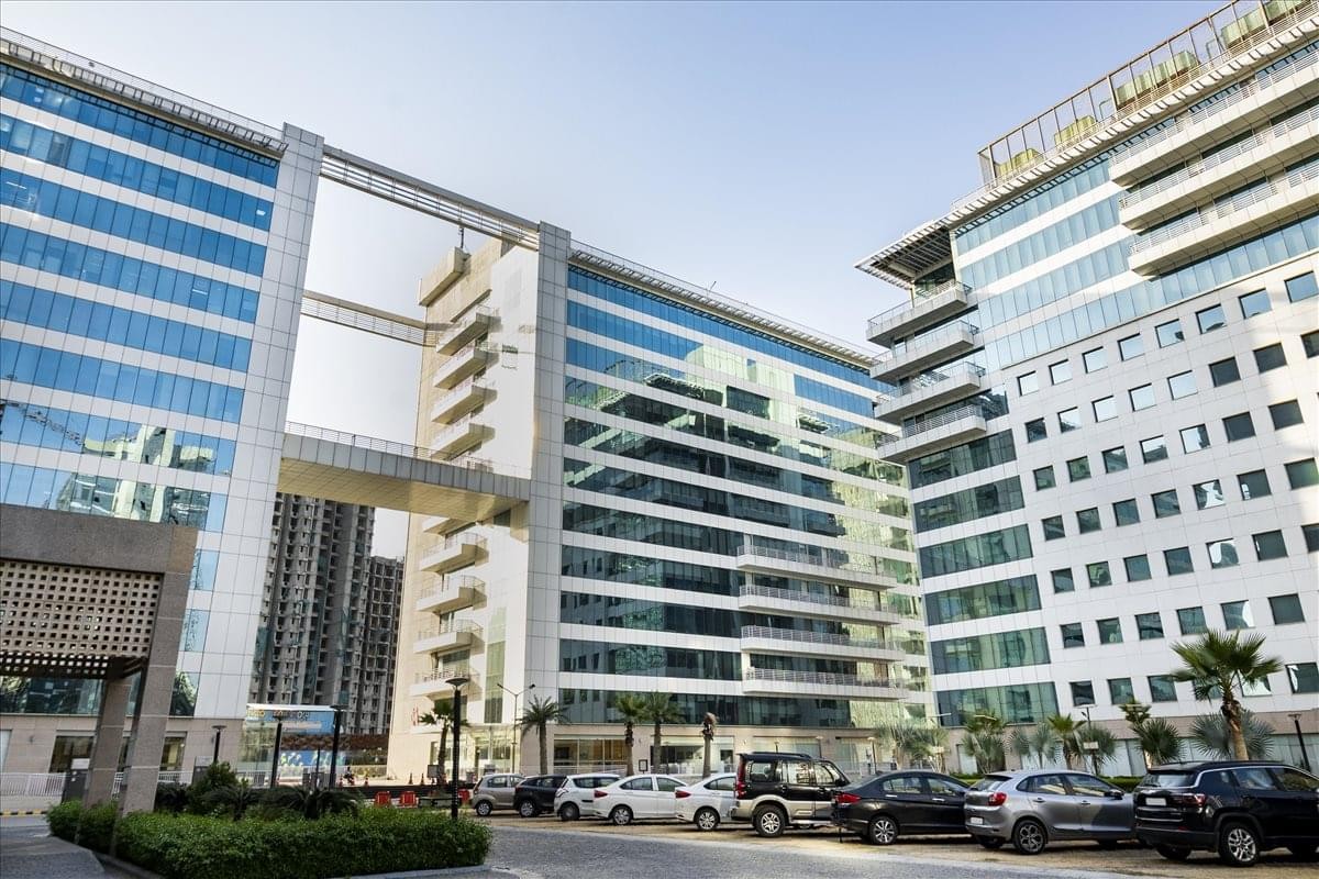 Exterior view of the modern glass and concrete facade at Assotech Business Cresterra.