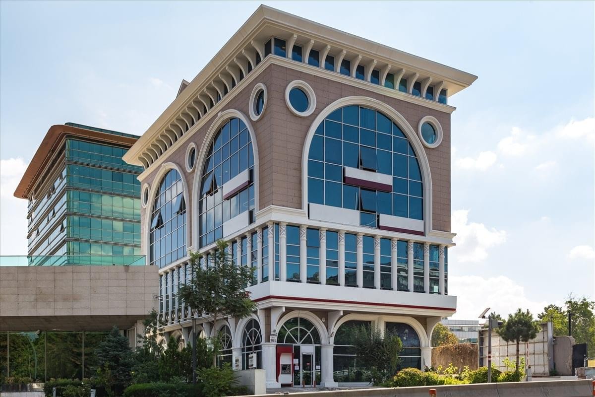 Exterior view of the ornate glass and stone facade at Atatürk Blv No:185.