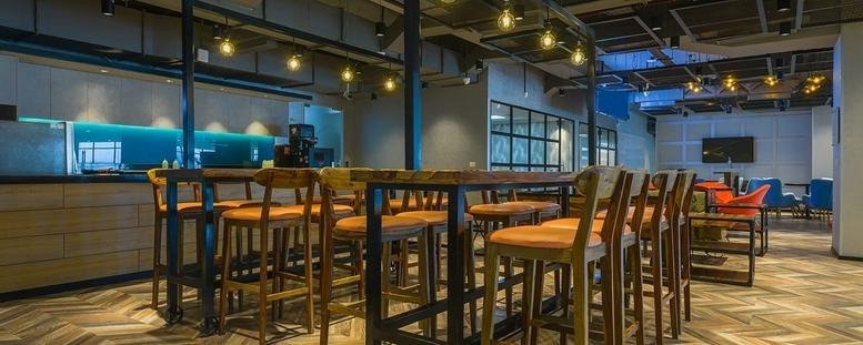 Spacious communal lounge at Awfis, Chemtex House, Chemtex Lane, Hiranandani Gardens, Powai, Mumbai with bar seating.