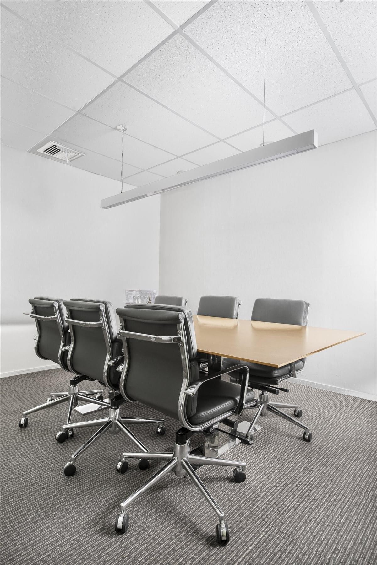 Professional meeting room at Bangna Tower A (F16) with ergonomic leather chairs and a light wood table.