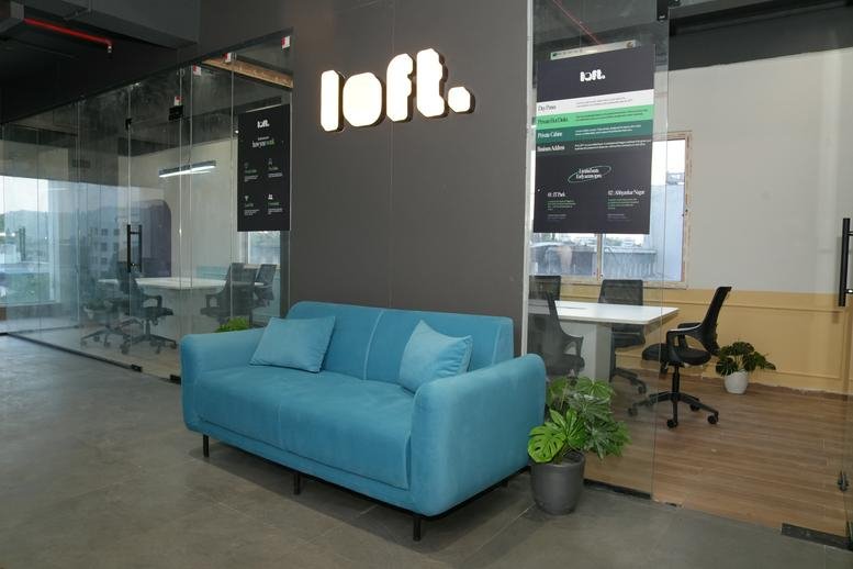 Lobby at Loft Coworking Space, Bhamti, Trimurti Nagar with a blue sofa and branded signage.