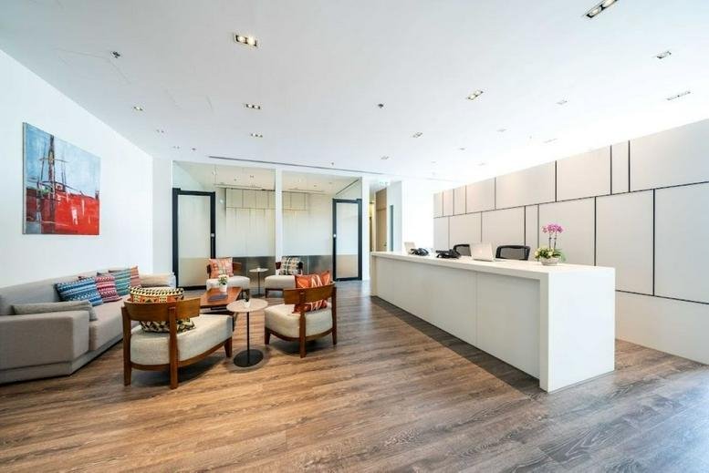 Spacious reception area at Billion Plaza II with a long white desk and stylish seating.
