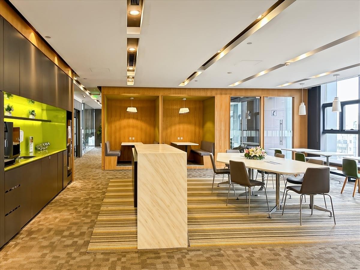 Expansive communal lounge with diverse seating options and modern lighting.