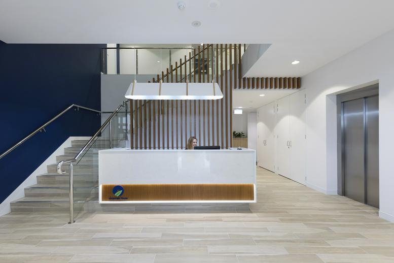Modern lobby with white reception desk at Building 5, 22 Magnolia Drive, Brookwater.