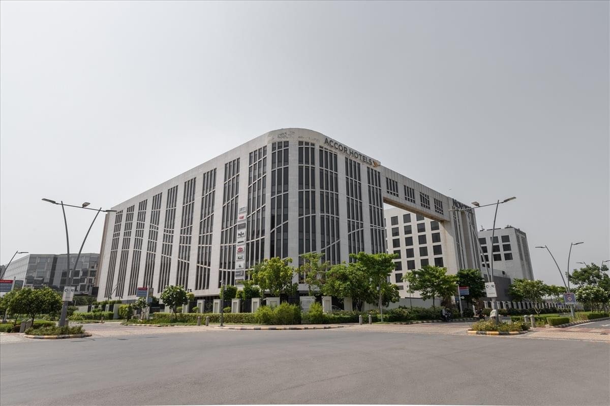 Exterior view of the modern Caddie Commercial Tower, AeroNew Delhi (DIAL) with its glass facade.